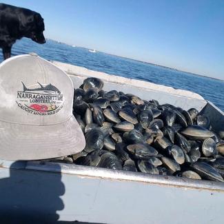 Fresh quahogs next to a Narragansett Bay Lobster hat