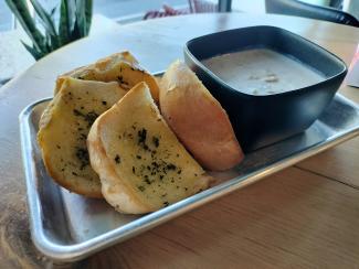 Bowl of chowder with toasted bread from White Owl Bar and Kitchen in Providence